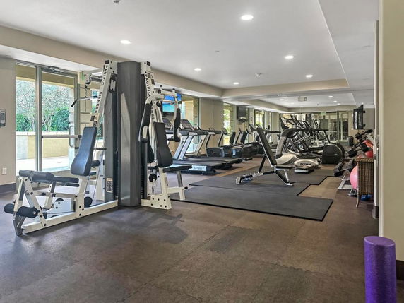 Indoor gym area with various exercise equipment.