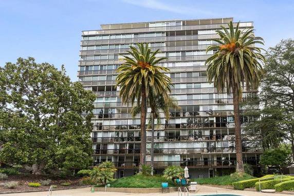 Front view of a high-rise glass building with multiple floors.