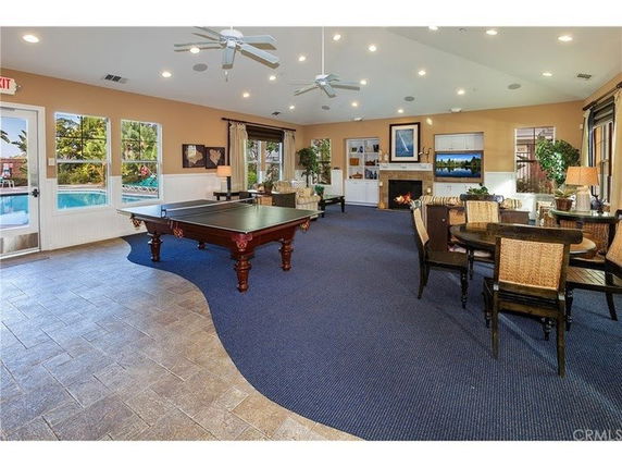 Interior of a recreation room with pool table and seating area.