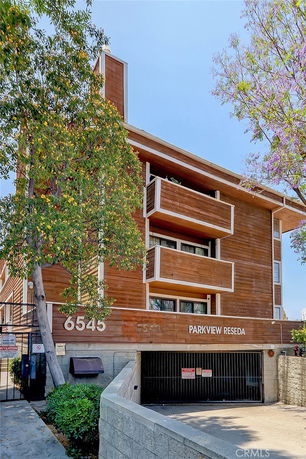 Front view of a multi-story wooden building named Parkview Reseda with balconies.