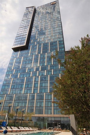 Front view of a tall modern building with glass facade.