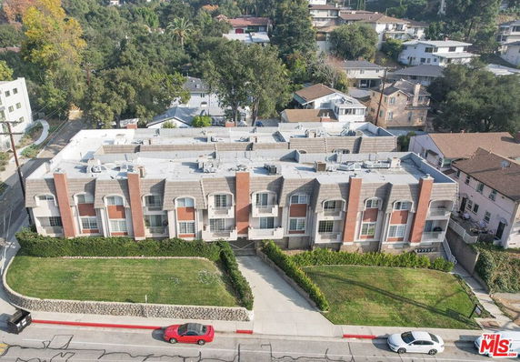 Front view of a multi-story residential building with brick and beige exterior.