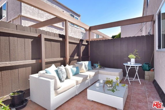 Outdoor patio area with seating and table.