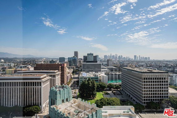 Panoramic view of a city skyline with various tall buildings.