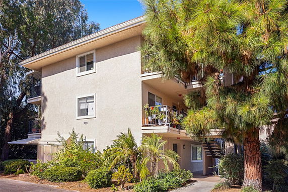 Front view of a multi-story residential building with balconies.