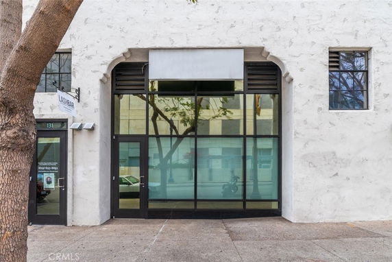 Front view of a commercial building with large window and door.