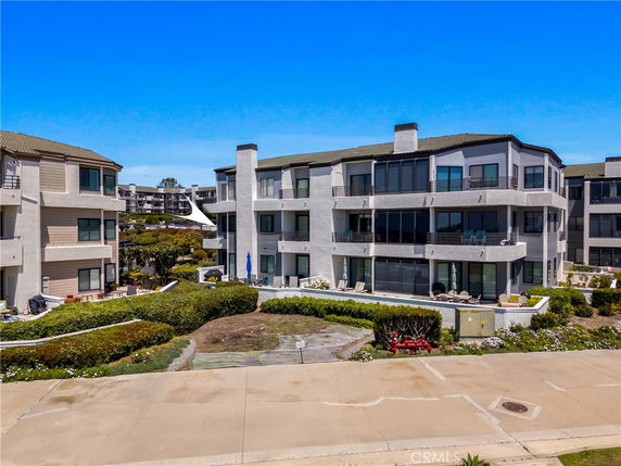 Front view of a multi-story residential building with balconies.
