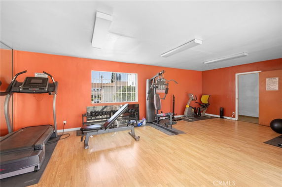 Indoor gym area with exercise equipment and orange walls.