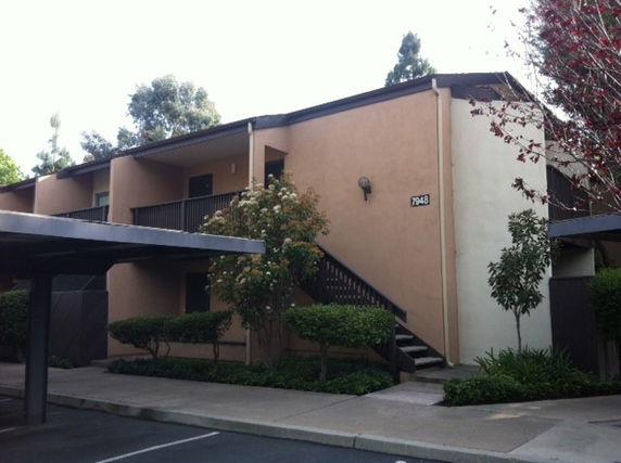 Front view of a two-story apartment building with external staircases.