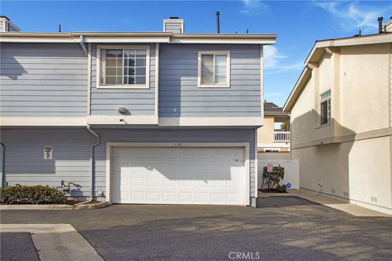Front view of a two-story house with a garage and blue siding.