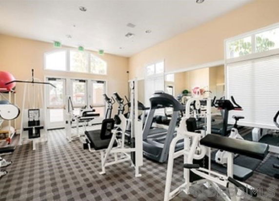 Indoor gym area with exercise equipment and machines.