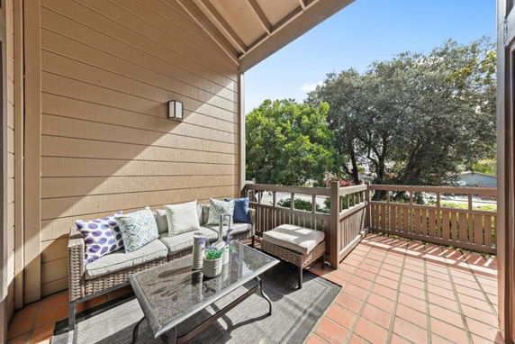 Terrace area with outdoor seating overlooking greenery.