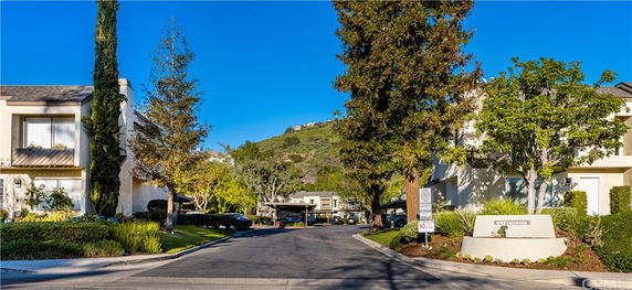 Front view of a residential area with two-story buildings and a driveway.