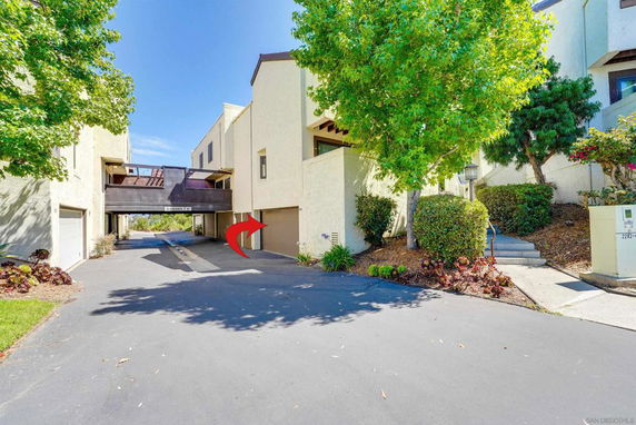 Front view of a multi-story residential building with garages.