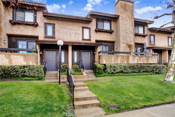 Front view of a two-story townhouse with multiple entrances.