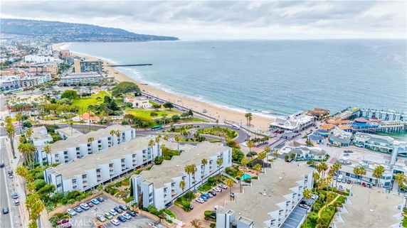 Wide angle view of coastal area with residential buildings and beach.
