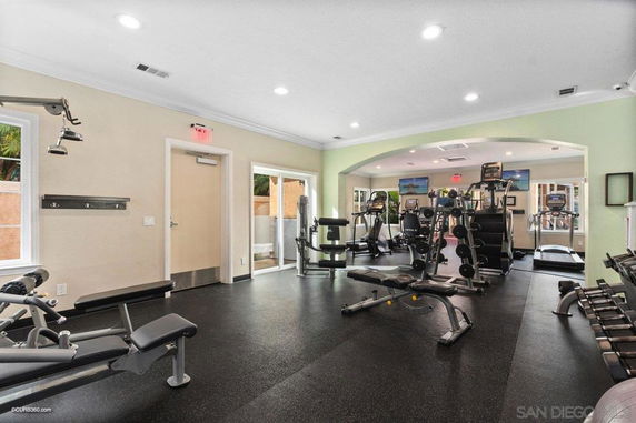 Indoor gym area with various exercise equipment and weight machines.
