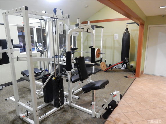 Indoor gym area with exercise equipment and weight machines.