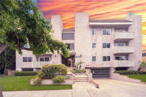 Front view of a multi-story apartment building with balconies.