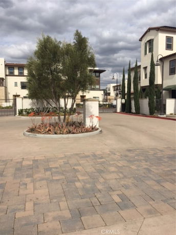 Front view of apartment buildings with multiple levels and modern design.
