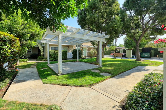 Front view of a house with a patio and pergola.