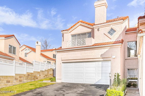 Front view of a two-story house with a double garage.