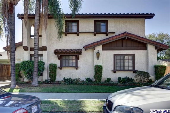 Front view of a two-story house with a traditional design and tiled roof.