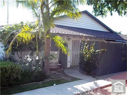 Front view of a single-story house with a gable roof and a porch.