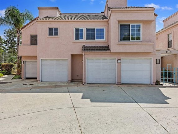 Front view of a two-story house with a double garage and a single garage.
