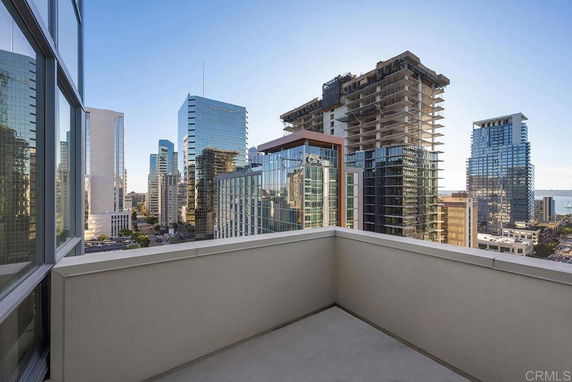 View from a rooftop terrace overlooking city skyscrapers.