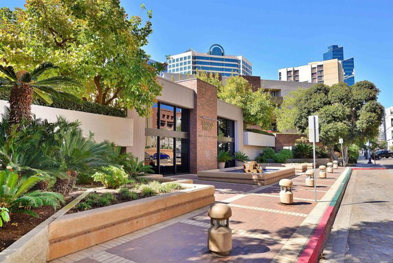Front view of a modern commercial building with landscaped surroundings.