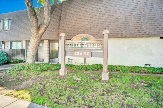 Front view of a building with a sign reading 'Villa Amigo' and an address number.