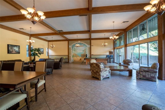 Interior of a club house with seating area and billiard table.