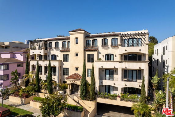Front view of a multi-story residential building with balconies.