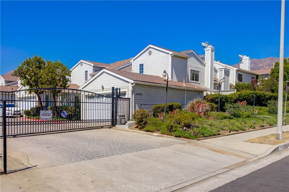 Front view of a multi-story residential building with gated entrance.