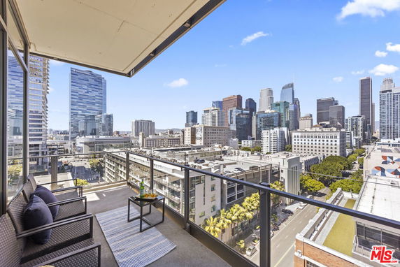 Panoramic view of a city skyline from a balcony.