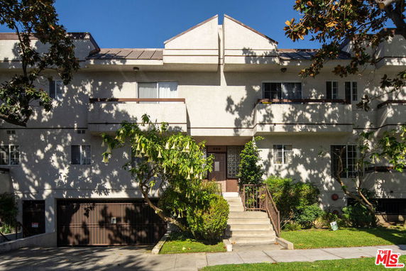 Front view of a multi-story residential building with balconies.