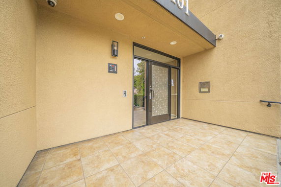 Entrance view of a building with glass doors and beige walls