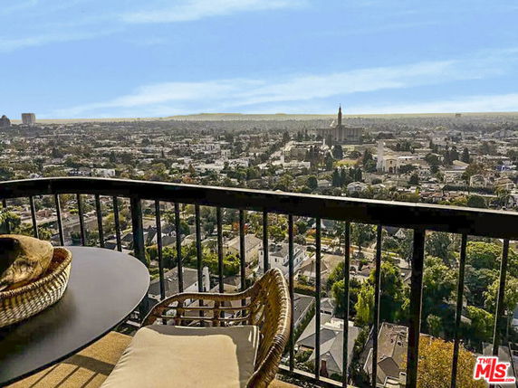 Panoramic view of cityscape from a balcony.