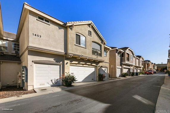 Front view of a two-story house with a double garage.