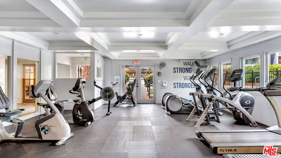 Interior view of a gym area with exercise equipment.