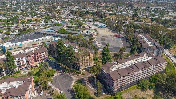 Aerial view of residential and commercial buildings in a suburban area.