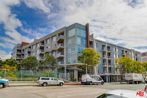 Front view of a multi-story modern apartment building with balconies.