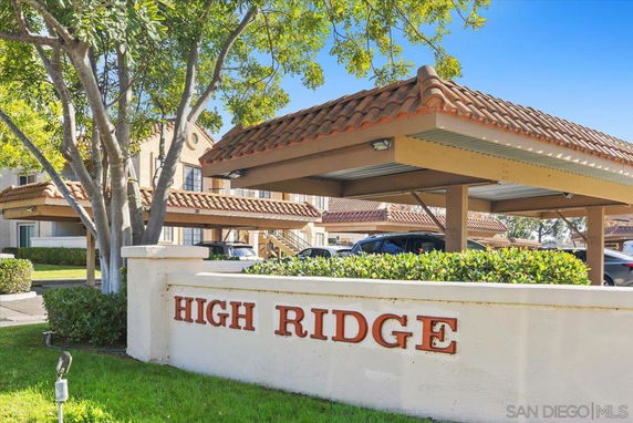 Outdoor parking area with a sign reading 'High Ridge' and covered parking spaces.