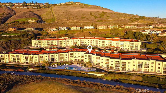 Elevated view of a large multi-story residential complex with red roofs.