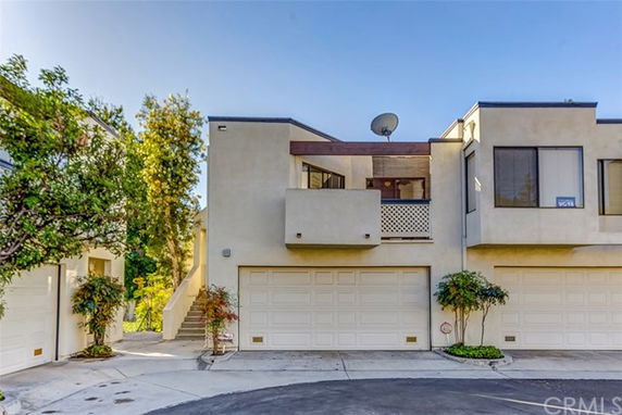 Front view of a modern multi-story house with two garages.