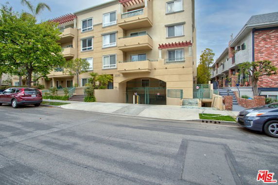 Front view of a multi-story apartment building with balconies.