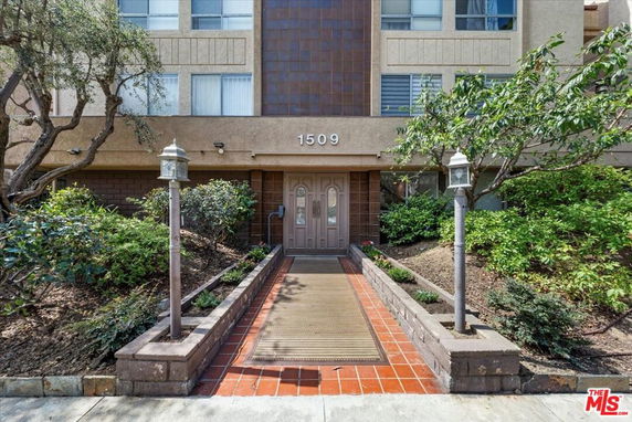 Front view of a multi-story building entrance with number 1509 above the door.