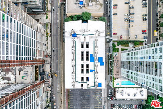 Aerial view of a building rooftop with multiple units and structures.