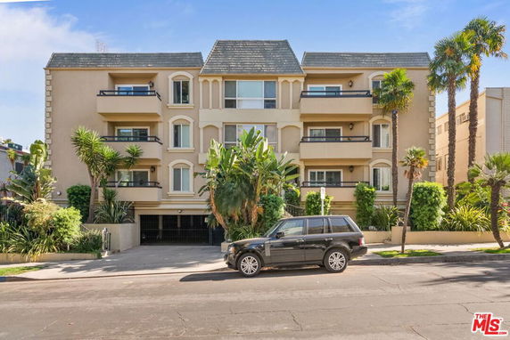 Front view of a multi-story residential building with balconies.